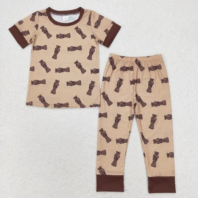 Tan toddler pajama set with tribal totem print and brown collar and cuffs, laid flat on white background